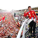 MONZA, ITALY - SEPTEMBER 01: Race winner Charles Leclerc of Monaco and Ferrari poses for a picture on the podium, with the fans down on the track during the F1 Grand Prix of Italy at Autodromo Nazionale Monza on September 01, 2024 in Monza, Italy. (Photo by Bryn Lennon - Formula 1/Formula 1 via Getty Images)