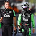 MONZA, ITALY - AUGUST 31: Twentieth qualifier Zhou Guanyu of China and Stake F1 Team Kick Sauber walks in the Pitlane during qualifying ahead of the F1 Grand Prix of Italy at Autodromo Nazionale Monza on August 31, 2024 in Monza, Italy. (Photo by Bryn Lennon - Formula 1/Formula 1 via Getty Images)