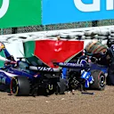 SUZUKA, JAPAN - APRIL 07: Daniel Ricciardo of Australia and Visa Cash App RB climbs out of his car after crashing with Alexander Albon of Thailand and Williams during the F1 Grand Prix of Japan at Suzuka International Racing Course on April 07, 2024 in Suzuka, Japan. (Photo by Clive Rose - Formula 1/Formula 1 via Getty Images)