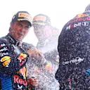 SUZUKA, JAPAN - APRIL 07: Second placed Sergio Perez of Mexico and Oracle Red Bull Racing celebrates with Craig Dear, Principal Aerodynamicist at Oracle RedÂ BullÂ Racing on the podium during the F1 Grand Prix of Japan at Suzuka International Racing Course on April 07, 2024 in Suzuka, Japan. (Photo by Bryn Lennon - Formula 1/Formula 1 via Getty Images)