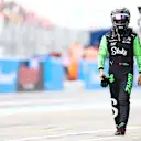 SUZUKA, JAPAN - APRIL 06: 20th placed qualifier Zhou Guanyu of China and Stake F1 Team Kick Sauber walks in the Pitlane during qualifying ahead of the F1 Grand Prix of Japan at Suzuka International Racing Course on April 06, 2024 in Suzuka, Japan. (Photo by Bryn Lennon - Formula 1/Formula 1 via Getty Images)