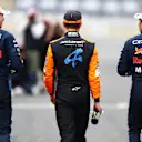 SUZUKA, JAPAN - APRIL 06: Race winner qualifier Max Verstappen of the Netherlands and Oracle Red Bull Racing (L), Second placed qualifier Sergio Perez of Mexico and Oracle Red Bull Racing (R) and Third placed qualifier Lando Norris of Great Britain and McLaren (C) walk in parc ferme during qualifying ahead of the F1 Grand Prix of Japan at Suzuka International Racing Course on April 06, 2024 in Suzuka, Japan. (Photo by Peter Fox/Getty Images)