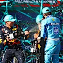 MIAMI, FLORIDA - MAY 05: Second placed Max Verstappen of the Netherlands and Oracle Red Bull Racing and Third placed Charles Leclerc of Monaco and Ferrari celebrate with Race winner Lando Norris of Great Britain and McLaren on the podium during the F1 Grand Prix of Miami at Miami International Autodrome on May 05, 2024 in Miami, Florida. (Photo by Mark Thompson/Getty Images)