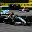 MIAMI, FLORIDA - MAY 04: Lewis Hamilton of Great Britain driving the (44) Mercedes AMG Petronas F1 Team W15 leads Yuki Tsunoda of Japan driving the (22) Visa Cash App RB VCARB 01 during the Sprint ahead of the F1 Grand Prix of Miami at Miami International Autodrome on May 04, 2024 in Miami, Florida. (Photo by Clive Mason/Getty Images)