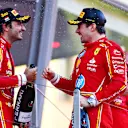MONTE-CARLO, MONACO - MAY 26: Race winner Charles Leclerc of Monaco and Ferrari and Third placed Carlos Sainz of Spain and Ferrari celebrate on the podium during the F1 Grand Prix of Monaco at Circuit de Monaco on May 26, 2024 in Monte-Carlo, Monaco. (Photo by Bryn Lennon - Formula 1/Formula 1 via Getty Images)