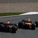ZANDVOORT, NETHERLANDS - AUGUST 25: Lando Norris of Great Britain driving the (4) McLaren MCL38 Mercedes leads Max Verstappen of the Netherlands driving the (1) Oracle Red Bull Racing RB20 during the F1 Grand Prix of Netherlands at Circuit Zandvoort on August 25, 2024 in Zandvoort, Netherlands. (Photo by Bryn Lennon - Formula 1/Formula 1 via Getty Images)