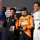 LUSAIL CITY, QATAR - NOVEMBER 30: Sprint winner Oscar Piastri of Australia and McLaren, Second placed Lando Norris of Great Britain and McLaren, Third placed George Russell of Great Britain and Mercedes and Khaby Lame pose for a photo in the Paddock during the Sprint ahead of the F1 Grand Prix of Qatar at Lusail International Circuit on November 30, 2024 in Lusail City, Qatar. (Photo by Bryn Lennon - Formula 1/Formula 1 via Getty Images)