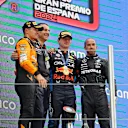 BARCELONA, SPAIN - JUNE 23: Race winner Max Verstappen of the Netherlands and Oracle Red Bull Racing, Second placed Lando Norris of Great Britain and McLaren and Third placed Lewis Hamilton of Great Britain and Mercedes celebrate on the podium during the F1 Grand Prix of Spain at Circuit de Barcelona-Catalunya on June 23, 2024 in Barcelona, Spain. (Photo by Joe Portlock - Formula 1/Formula 1 via Getty Images)
