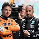 BARCELONA, SPAIN - JUNE 22: Pole position qualifier Lando Norris of Great Britain and McLaren and Third placed qualifier Lewis Hamilton of Great Britain and Mercedes talk in parc ferme during qualifying ahead of the F1 Grand Prix of Spain at Circuit de Barcelona-Catalunya on June 22, 2024 in Barcelona, Spain. (Photo by Mark Sutton - Formula 1/Formula 1 via Getty Images)