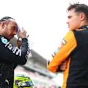 BARCELONA, SPAIN - JUNE 22: Pole position qualifier Lando Norris of Great Britain and McLaren and Third placed qualifier Lewis Hamilton of Great Britain and Mercedes talk in parc ferme during qualifying ahead of the F1 Grand Prix of Spain at Circuit de Barcelona-Catalunya on June 22, 2024 in Barcelona, Spain. (Photo by Clive Rose - Formula 1/Formula 1 via Getty Images)