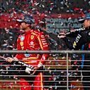 AUSTIN, TEXAS - OCTOBER 20: Second placed Carlos Sainz of Spain and Ferrari and Third placed Max Verstappen of the Netherlands and Oracle Red Bull Racing celebrate on the podium after the F1 Grand Prix of United States at Circuit of The Americas on October 20, 2024 in Austin, Texas. (Photo by Jared C. Tilton/Getty Images)
