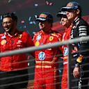AUSTIN, TEXAS - OCTOBER 20: Race winner Charles Leclerc of Monaco and Ferrari, Second placed Carlos Sainz of Spain and Ferrari and Third placed Max Verstappen of the Netherlands and Oracle Red Bull Racing pose for a photo on the podium after the F1 Grand Prix of United States at Circuit of The Americas on October 20, 2024 in Austin, Texas. (Photo by Rudy Carezzevoli/Getty Images)