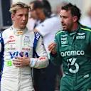AUSTIN, TEXAS - OCTOBER 19: 16th placed Liam Lawson of New Zealand and Visa Cash App RB and 18th placed Fernando Alonso of Spain and Aston Martin F1 Team talk in parc ferme during the Sprint ahead of the F1 Grand Prix of United States at Circuit of The Americas on October 19, 2024 in Austin, Texas. (Photo by Rudy Carezzevoli/Getty Images)