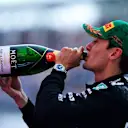 MELBOURNE, AUSTRALIA - MARCH 16: Third placed George Russell of Great Britain and Mercedes AMG Petronas F1 Team celebrates with Champagne on the podium  during the F1 Grand Prix of Australia at Albert Park Grand Prix Circuit on March 16, 2025 in Melbourne, Australia. (Photo by Mario Renzi - Formula 1/Formula 1 via Getty Images)