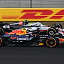 SHANGHAI, CHINA - MARCH 23: Liam Lawson of New Zealand driving the (30) Oracle Red Bull Racing RB21 and Oliver Bearman of Great Britain driving the (87) Haas F1 VF-25 Ferrari battle for track position during the F1 Grand Prix of China at Shanghai International Circuit on March 23, 2025 in Shanghai, China. (Photo by Clive Mason/Getty Images)