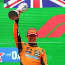 SHANGHAI, CHINA - MARCH 23: Second placed Lando Norris of Great Britain and McLaren lifts his trophy on the podium during the F1 Grand Prix of China at Shanghai International Circuit on March 23, 2025 in Shanghai, China. (Photo by Clive Rose/Getty Images)