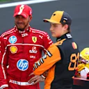 SHANGHAI, CHINA - MARCH 22: Sprint winner Lewis Hamilton of Great Britain and Scuderia Ferrari and Second placed Oscar Piastri of Australia and McLaren talk in parc ferme  during the Sprint ahead of the F1 Grand Prix of China at Shanghai International Circuit on March 22, 2025 in Shanghai, China. (Photo by Clive Rose/Getty Images)