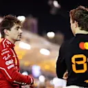 BAHRAIN, BAHRAIN - APRIL 12: Pole position qualifier Oscar Piastri of Australia and McLaren talks with Third placed qualifier Charles Leclerc of Monaco and Scuderia Ferrari in parc ferme during qualifying ahead of the F1 Grand Prix of Bahrain at Bahrain International Circuit on April 12, 2025 in Bahrain, Bahrain. (Photo by Bryn Lennon - Formula 1/Formula 1 via Getty Images)