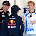 IMOLA, ITALY - MAY 18: Max Verstappen of the Netherlands and Oracle Red Bull Racing Yuki Tsunoda of Japan and Oracle Red Bull Racing and Liam Lawson of New Zealand and Visa Cash App Racing Bulls talk prior to the F1 Grand Prix of Emilia-Romagna at Autodromo Internazionale Enzo e Dino Ferrari on May 18, 2025 in Imola, Italy. (Photo by Mark Thompson/Getty Images)