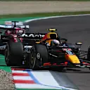 IMOLA, ITALY - MAY 18: Yuki Tsunoda of Japan driving the (22) Oracle Red Bull Racing RB21 leads Charles Leclerc of Monaco driving the (16) Scuderia Ferrari SF-25 on track during the F1 Grand Prix of Emilia-Romagna at Autodromo Internazionale Enzo e Dino Ferrari on May 18, 2025 in Imola, Italy. (Photo by Mark Sutton - Formula 1/Formula 1 via Getty Images)