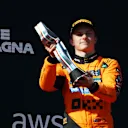 IMOLA, ITALY - MAY 18: Third placed Oscar Piastri of Australia and McLaren lifts his trophy on the podium during the F1 Grand Prix of Emilia-Romagna at Autodromo Internazionale Enzo e Dino Ferrari on May 18, 2025 in Imola, Italy. (Photo by Clive Rose/Getty Images)