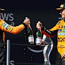 IMOLA, ITALY - MAY 18: Second placed Lando Norris of Great Britain and McLaren and Third placed Oscar Piastri of Australia and McLaren celebrate with Champagne on the podium during the F1 Grand Prix of Emilia-Romagna at Autodromo Internazionale Enzo e Dino Ferrari on May 18, 2025 in Imola, Italy. (Photo by Ryan Pierse/Getty Images)