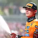 IMOLA, ITALY - MAY 18: Second placed Lando Norris of Great Britain and McLaren sprays Champagne on the podium during the F1 Grand Prix of Emilia-Romagna at Autodromo Internazionale Enzo e Dino Ferrari on May 18, 2025 in Imola, Italy. (Photo by Bryn Lennon - Formula 1/Formula 1 via Getty Images)