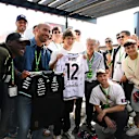 IMOLA, ITALY - MAY 16: Lorenzo De Silvestri of FC Bologna swaps shirts with Andrea Kimi Antonelli of Italy and Mercedes AMG Petronas F1 Team during practice ahead of the F1 Grand Prix of Emilia-Romagna at Autodromo Internazionale Enzo e Dino Ferrari on May 16, 2025 in Imola, Italy. (Photo by Mark Sutton - Formula 1/Formula 1 via Getty Images)