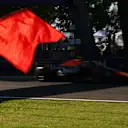 IMOLA, ITALY - MAY 16: A marshal waves a red flag as Yuki Tsunoda of Japan driving the (22) Oracle Red Bull Racing RB21 passes during practice ahead of the F1 Grand Prix of Emilia-Romagna at Autodromo Internazionale Enzo e Dino Ferrari on May 16, 2025 in Imola, Italy. (Photo by Mark Thompson/Getty Images)