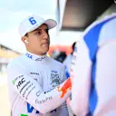 IMOLA, ITALY - MAY 17: Isack Hadjar of France and Visa Cash App Racing Bulls greets a teammate on the pit wall during qualifying ahead of the F1 Grand Prix of Emilia-Romagna at Autodromo Internazionale Enzo e Dino Ferrari on May 17, 2025 in Imola, Italy. (Photo by Rudy Carezzevoli/Getty Images)
