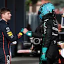 IMOLA, ITALY - MAY 17: Second placed qualifier Max Verstappen of the Netherlands and Oracle Red Bull Racing and Third placed qualifier George Russell of Great Britain and Mercedes AMG Petronas F1 Team congratulate each other in parc ferme during qualifying ahead of the F1 Grand Prix of Emilia-Romagna at Autodromo Internazionale Enzo e Dino Ferrari on May 17, 2025 in Imola, Italy. (Photo by Mark Thompson/Getty Images)