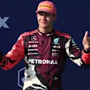 MIAMI, FLORIDA - MAY 04: Third placed George Russell of Great Britain and Mercedes AMG Petronas F1 Team on the podium with his trophy during the F1 Grand Prix of Miami at Miami International Autodrome on May 04, 2025 in Miami, Florida. (Photo by Clive Rose/Getty Images)