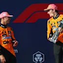 MIAMI, FLORIDA - MAY 04: Second placed Lando Norris of Great Britain and McLaren and Race winner Oscar Piastri of Australia and McLaren talk on the podium during the F1 Grand Prix of Miami at Miami International Autodrome on May 04, 2025 in Miami, Florida. (Photo by Clive Rose/Getty Images)