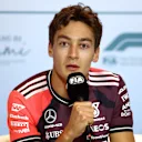 MIAMI, FLORIDA - MAY 01: George Russell of Great Britain and Mercedes AMG Petronas F1 Team speaks in the Drivers Press Conference during previews ahead of the F1 Grand Prix of Miami at Miami International Autodrome on May 01, 2025 in Miami, Florida. (Photo by Clive Rose/Getty Images)