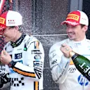 MONTE-CARLO, MONACO - MAY 25: Second placed Charles Leclerc of Monaco and Scuderia Ferrari sprays champagne in the face of Third placed Oscar Piastri of Australia and McLaren on the podium during the F1 Grand Prix of Monaco at Circuit de Monaco on May 25, 2025 in Monte-Carlo, Monaco. (Photo by Clive Rose/Getty Images)
