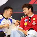 MONTE-CARLO, MONACO - MAY 22: Isack Hadjar of France and Visa Cash App Racing Bulls and Charles Leclerc of Monaco and Scuderia Ferrari talk in the Drivers Press Conference during previews ahead of the F1 Grand Prix of Monaco at Circuit de Monaco on May 22, 2025 in Monte-Carlo, Monaco. (Photo by Clive Rose/Getty Images)