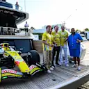 MIAMI, FLORIDA - APRIL 29: DJ Kahled poses for a photo alongside Liam Lawson of New Zealand and