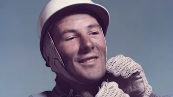 British racing driver Stirling Moss, circa 1955. He is wearing the badge of the British Racing