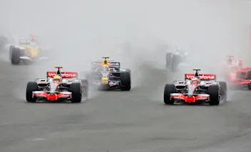 NORTHAMPTON, UNITED KINGDOM - JULY 06:  Lewis Hamilton (L) of Great Britain and McLaren Mercedes and Heikki Kovalainen (R) of Finland and McLaren Mercedes lead the field into the first corner at the start of the British Formula One Grand Prix at Silverstone on July 6, 2008 in Northampton, England.  (Photo by Mark Thompson/Getty Images)