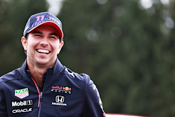 SPA, BELGIUM - AUGUST 26: Sergio Perez of Mexico and Red Bull Racing looks on in the Paddock during