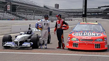 NASCAR's Jeff Gordon (R) of the US and F-1's Juan Pablo Montoya of Columbia talk before trading
