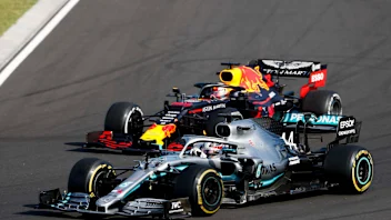 HUNGARORING, HUNGARY - AUGUST 04: Lewis Hamilton, Mercedes AMG F1 W10 overtakes Max Verstappen, Red