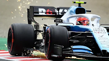 SUZUKA, JAPAN - OCTOBER 11: Sparks fly behind Robert Kubica of Poland driving the (88) Rokit