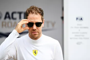 MELBOURNE, AUSTRALIA - MARCH 12: Sebastian Vettel of Germany and Ferrari walks in the Paddock