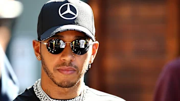 MELBOURNE, AUSTRALIA - MARCH 12: Lewis Hamilton of Great Britain and Mercedes GP walks in the
