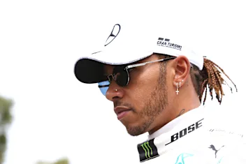 MELBOURNE, AUSTRALIA - MARCH 12: Lewis Hamilton of Great Britain and Mercedes GP walks in the