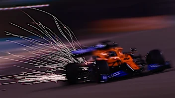 BAHRAIN, BAHRAIN - NOVEMBER 27: Sparks fly behind Carlos Sainz of Spain driving the (55) McLaren F1
