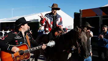 AUSTIN, TEXAS - OCTOBER 20: Daniel Ricciardo of Australia and McLaren pets a horse in the Paddock