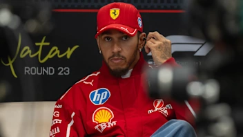 LUSAIL CITY, QATAR - NOVEMBER 27: Lewis Hamilton of Great Britain and Scuderia Ferrari looks on in
