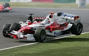 SUZUKA, JAPAN - OCTOBER 09:  Jarno Trulli of Italy and Toyota collides with Takuma Sato of Japan
